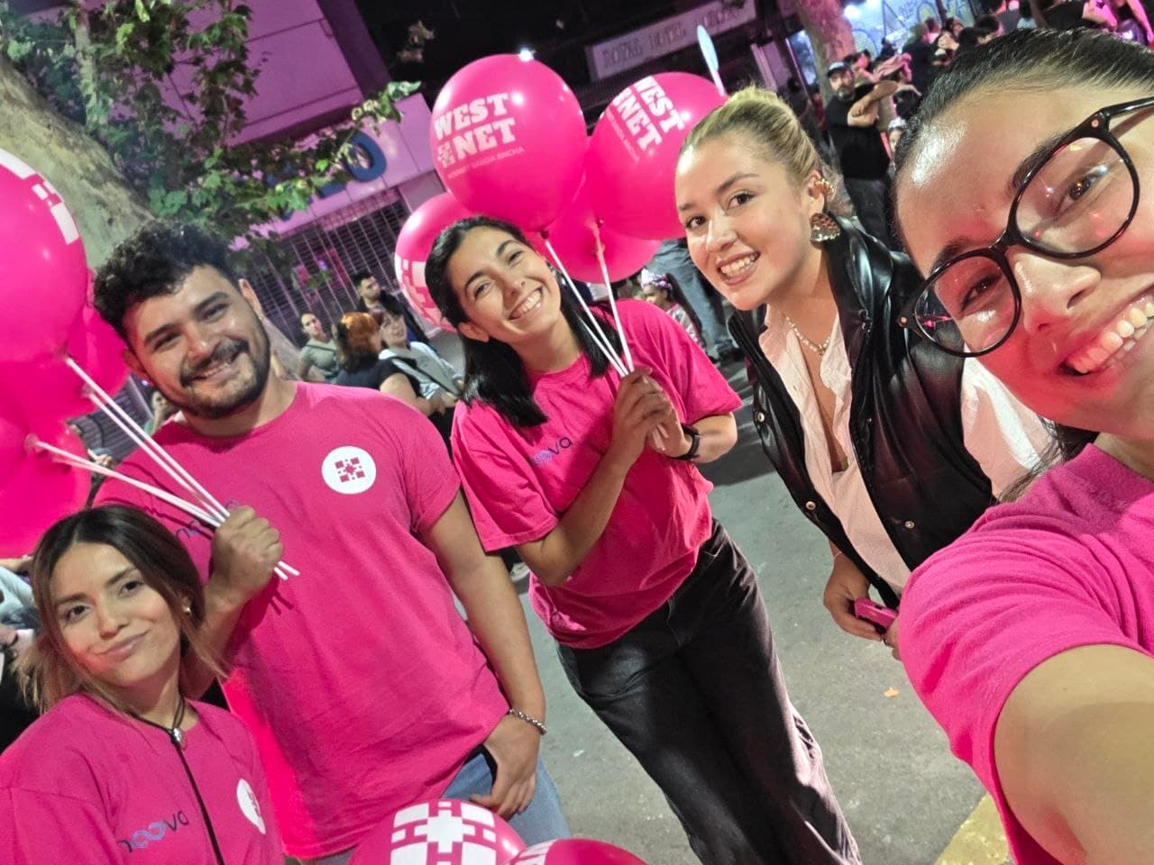 Equipo de Westnet y Noova con globos rosas durante una noche de Vendimia